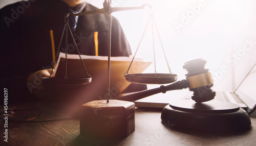 justice and law concept.Male judge in a courtroom on wooden table and Counselor or Male lawyer working in office. Legal law, advice and justice concept.