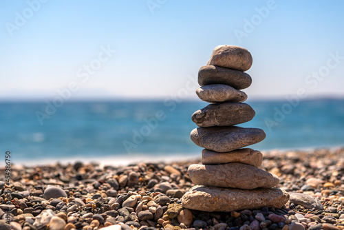creating a composition by stacking stones at the seaside