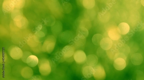 green abstract background of blurred lights with bokeh effect