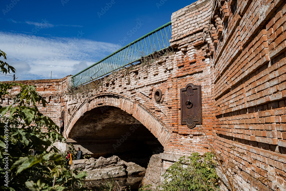 Ancient stone bridge over the river. Brick construction of the bridge. Arch construction for crossing the water.