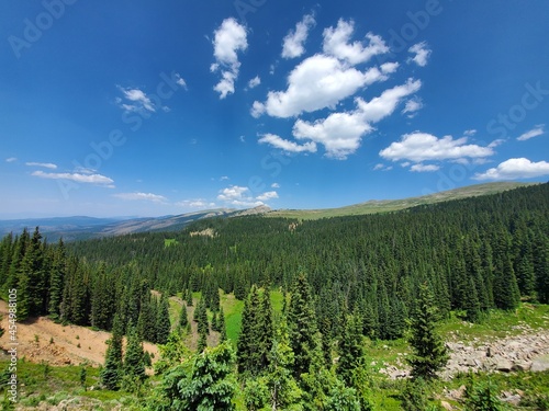 Mountains, forests and valleys of Indian Peaks Wilderness in Arapaho National Forest, Colorado on clear sunny summer afternoon.