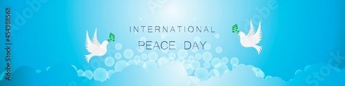 Sky and two pigeons with an olive branch above the clouds. Day of peace. 