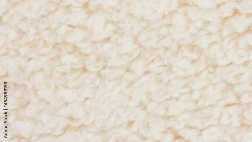 Amination beige sherpa textured fabric background Amination beige sherpa textured fabric background