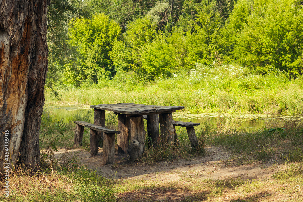 old table and bench for travelers on the river bank