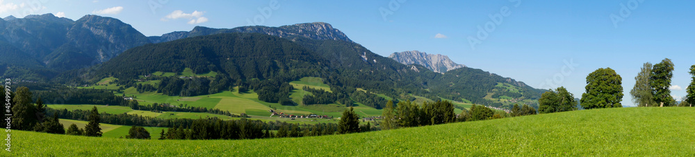 a scenic view of a little village and the green meadows in the Austrian Alps of the Schladming-Dachstein region (Austria)