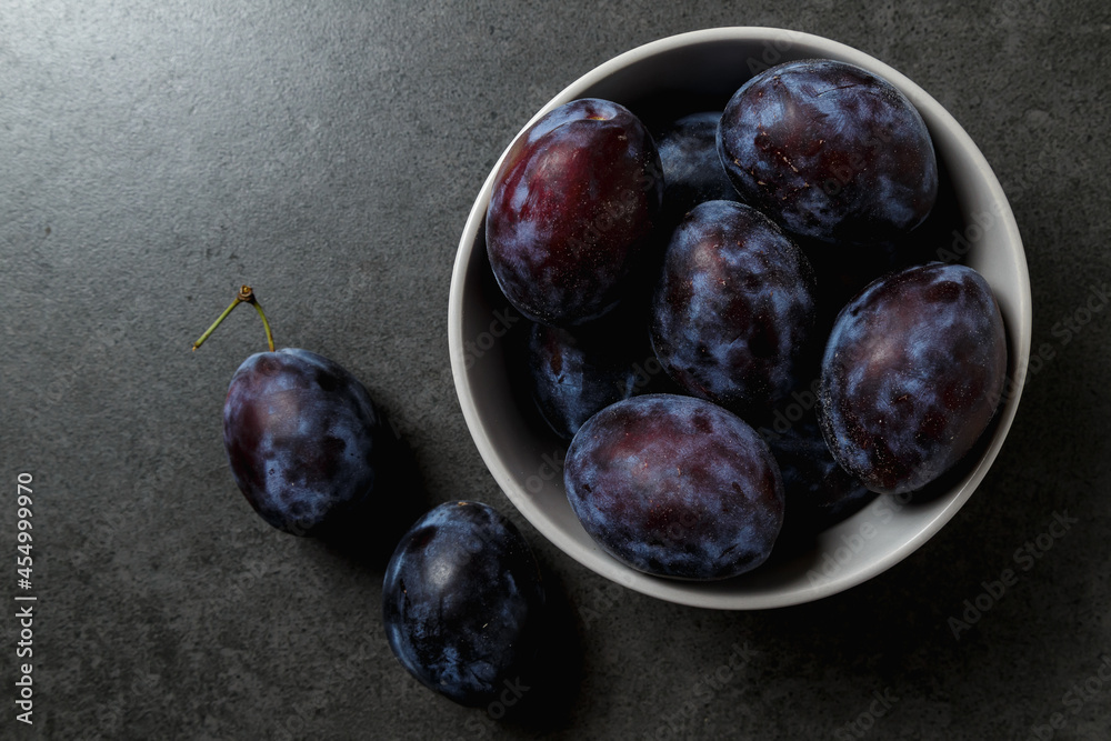 Fresh plums. Fruits. On a dark background. Top view. Copy space.