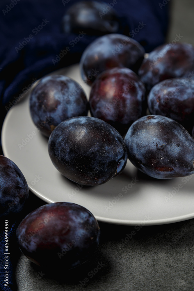 Fresh plums. Fruits. On a dark background. Copy space.