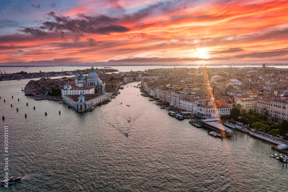 Naklejka premium Magical evening sunset view over beautiful Venice in Italy. Aerial view of the Venice lagoon with a beautiful city view.