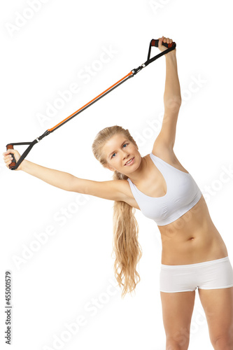 Woman exercising with resistance band on white