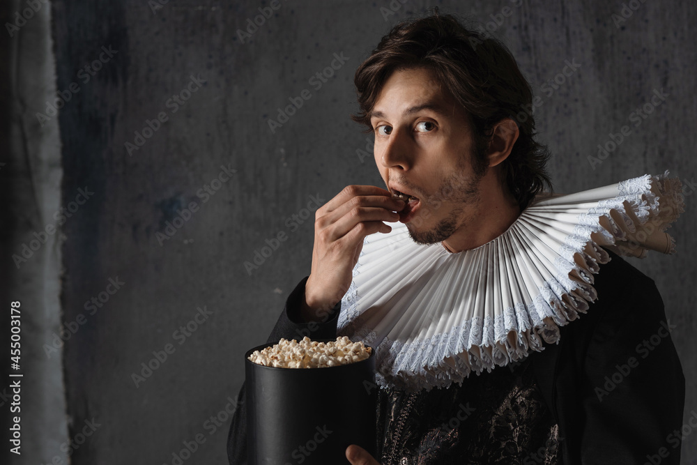 Cinema spectator of the Renaissance, a man in a medieval collar eats popcorn,  Stock Photo | Adobe Stock