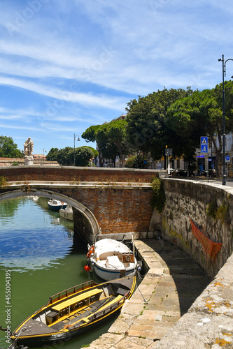 The St John Nepomuceno bridge with the statue of the saint over one of the canals in the New Venice, a neighborhood similar to Venice, Livorno, Tuscany photo