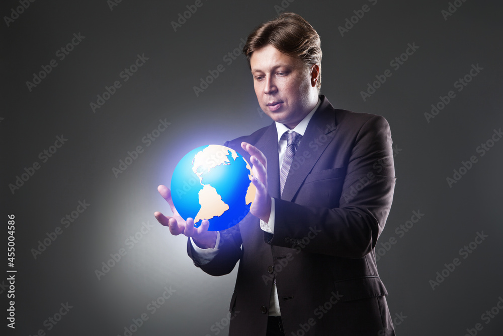 Hand of Business Man Hold Earth Globe on dark Hand of Business Man Hold Earth Globe on dark