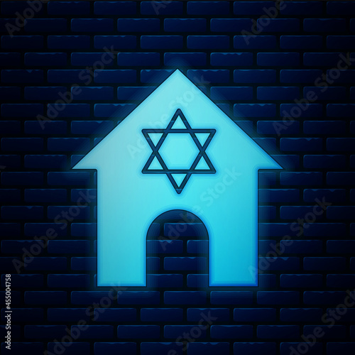 Glowing neon Jewish synagogue building or jewish temple icon isolated on brick wall background. Hebrew or judaism construction with David star. Vector