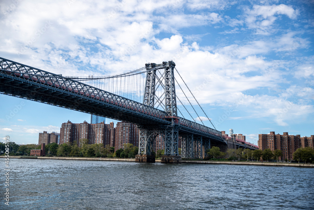 The Williamsburg Bridge is a suspension bridge in New York City across the East River connecting the Lower East Side of Manhattan at Delancey Street with the Williamsburg neighborhood of Brooklyn.