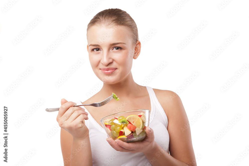 Pretty girl eating fruit salad isolated Pretty girl eating fruit salad isolated