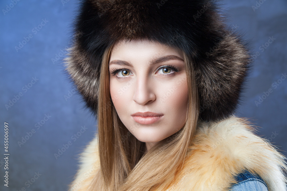 Beautiful woman in big fur hat and vest Beautiful woman in big fur hat and vest