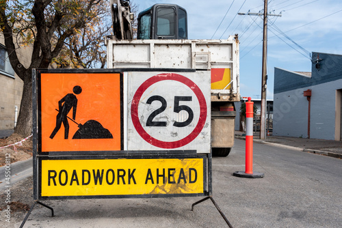 Signage for roadworks on a city street, with a 25 kilometre per hour speed limit