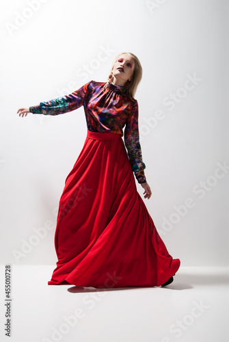 Fashion photo of young woman in red dress. Studio