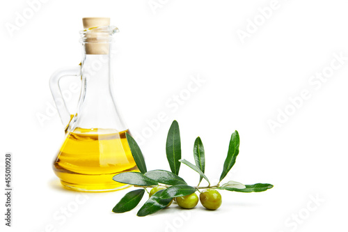Olive oil and branch with olives on white