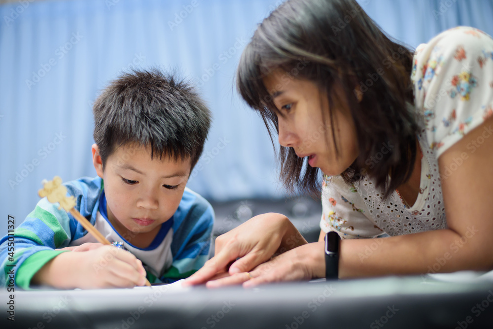 children boy doing homework with mother, kid write paper, family concept, learning time, student, back to school
children boy doing homework with mother, kid write paper, family concept, learning time, student, back to school
