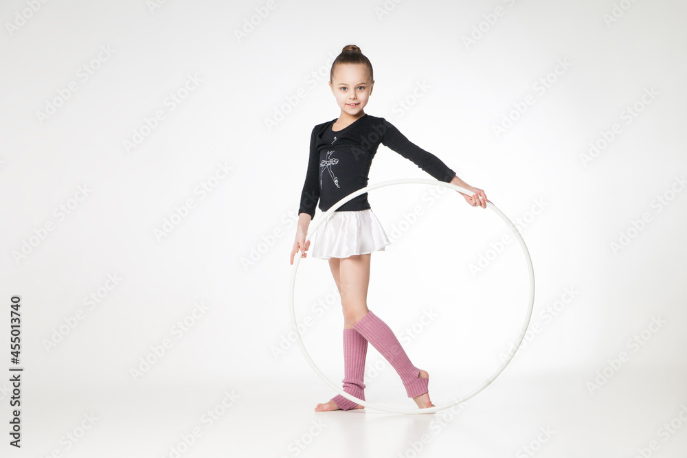 Portrait of a pretty little girl doing gymnastics over white background Portrait of a pretty little girl doing gymnastics over white background
