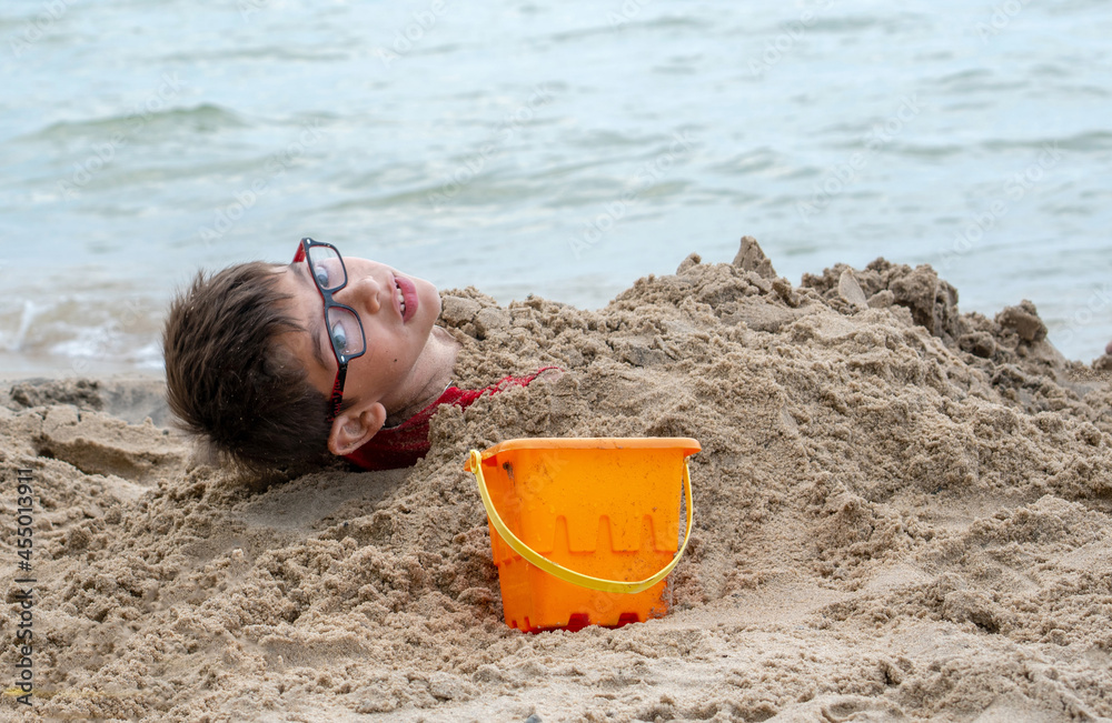 Young boy buried in the sand appears to be trapped! Young boy buried in the sand appears to be trapped!