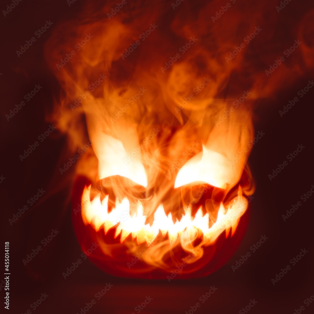 Fiery red hot Halloween jack o lantern pumpkin carved with scary evil face glowing brightly with thick smoke. Fiery red hot Halloween jack o lantern pumpkin carved with scary evil face glowing brightly with thick smoke.