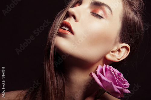 Portrait of beautiful brunette woman with rose © julenochek