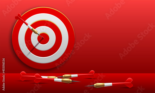 Red dart arrow hitting in the target center of dartboard