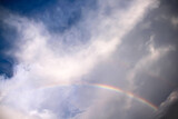 Close up rainbow on cloud blue sky background after rain