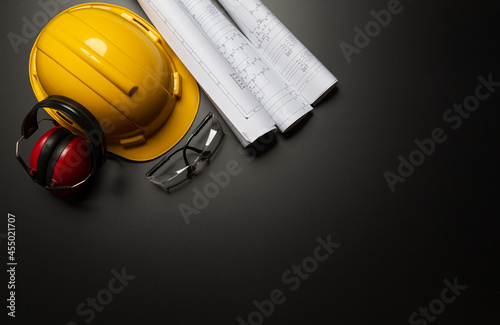 Work safety. Construction site protective equipment on wooden background  flat lay  copy space  top view