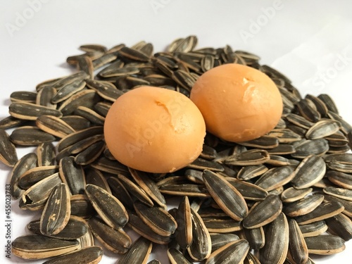 Mochi with salted egg yolks placed on top of a pile of sunflowers.