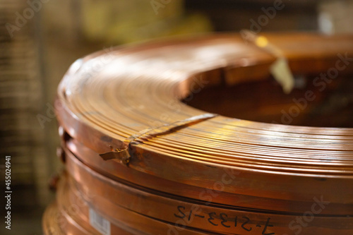 Rolls of flat copper products close-up. Copper tape in bundles. Copper rolling.
