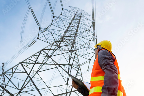 Engineering working on High-voltage tower, Check the information on paper. photo