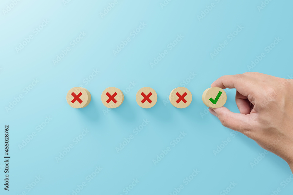 Checklist and check mark concept. Check mark and x sign symbol on wooden blocks on light blue background