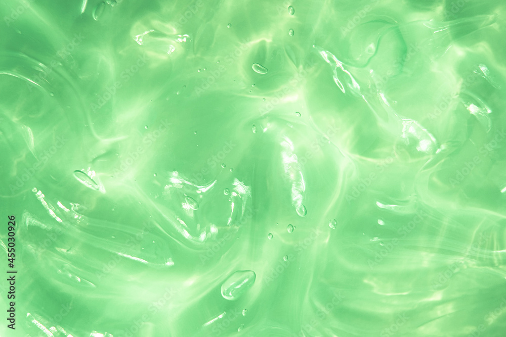 Green water Aloe Vera gel smudged texture. Abstract clear cosmetic cream, face serum, moisturizer background