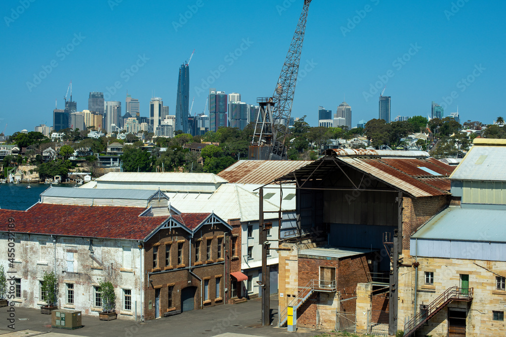 View of city skyline with industrial buildings in foreground, Sydney, NSW, Australia
