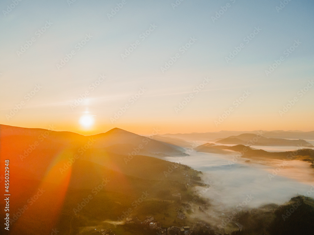 aerial view of sunrise above mountain range