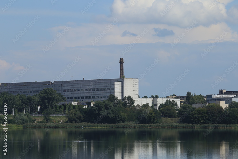 Factory with a chimney by the lake