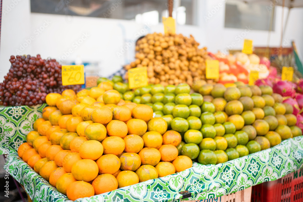 fruits and vegetables at the market.Orange fruit on table market .Orange juice sales.street food market with fruit.