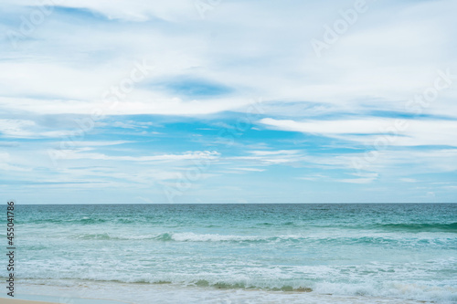 beach and blue sky.Landscape waves nature splashes sand beach on sunlight.