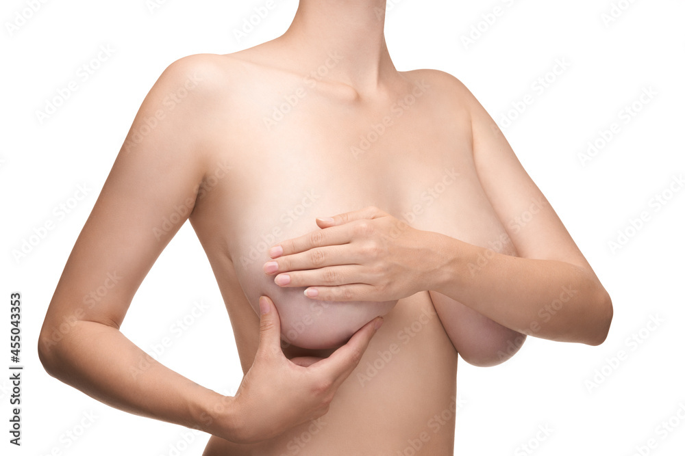 young woman feels her breasts as a precaution. young woman feels her breasts as a precaution.