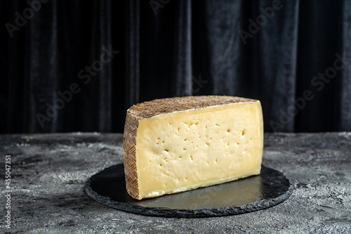 spanish manchego aged cheeses on rustic wooden table. banner, menu, recipe place for text photo