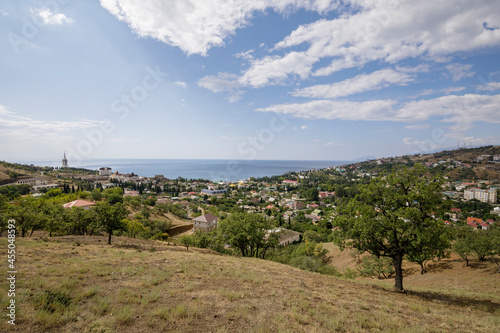 Malorechenskoye village, Crimea, August 15, 2021: View of the Malorechenskoye village and the Black Sea from the hill.