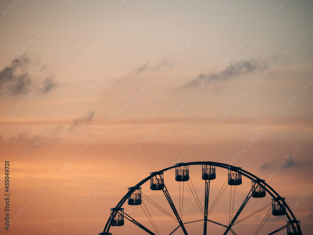 Silhouette of a Ferris wheel at sunset