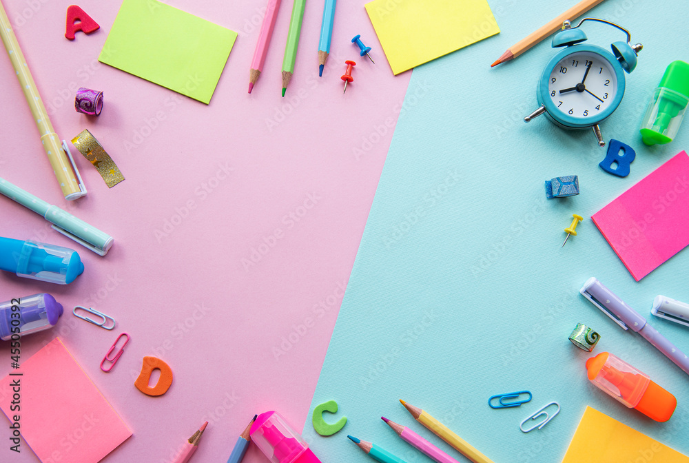 Frame of different stationery on pink and blue background Frame of different stationery on pink and blue background