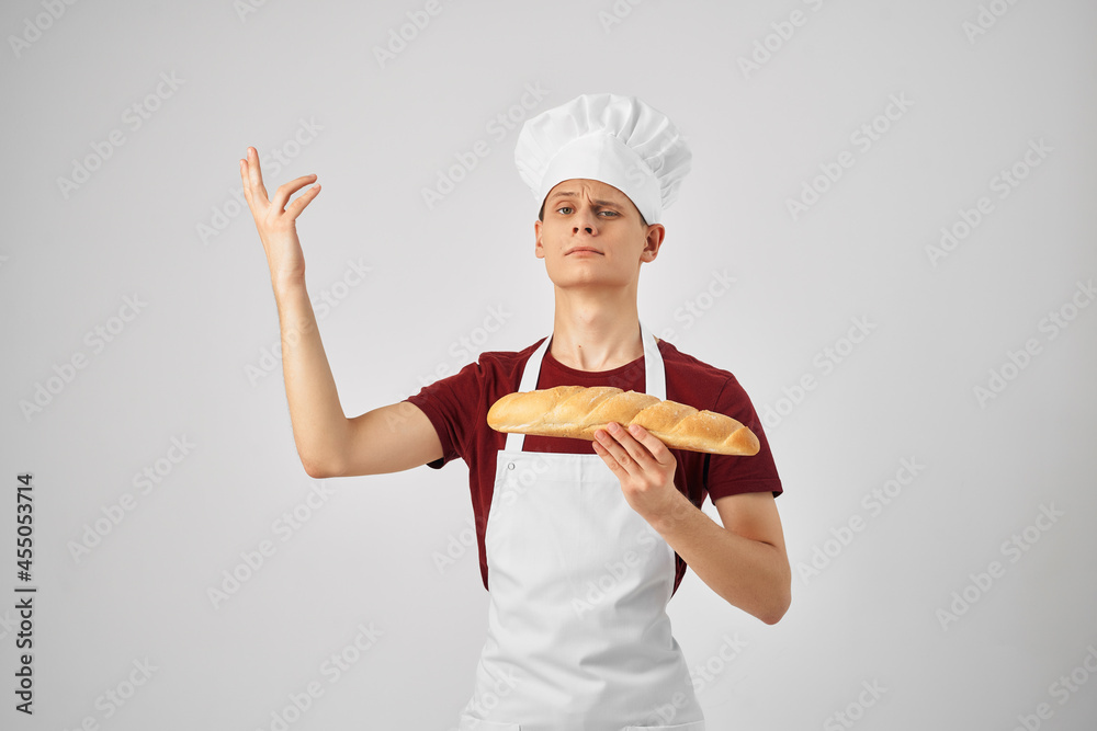 male baker Holding a loaf of bread making baked goods male baker Holding a loaf of bread making baked goods