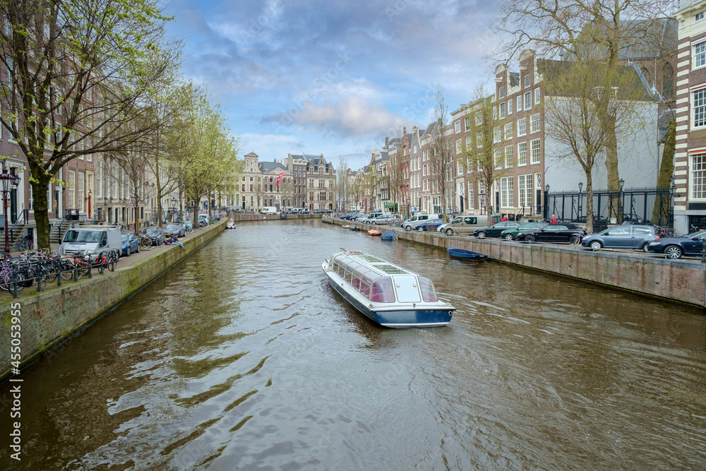 A canal boat sails through the Herengracht in Amsterdam, Noord-Holland province, The Netherlands