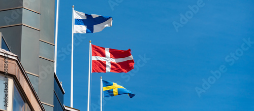 Group of scandinavian flags consist of Finland, Sweden and Denmark on the top of building.