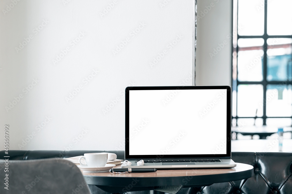Mockup blank white screen laptop computer on wooden table in cafe room. Mockup blank white screen laptop computer on wooden table in cafe room.